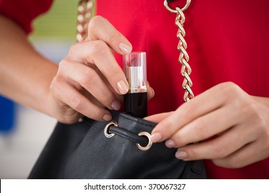 Midsection Of Woman Stealing Lipstick At Supermarket