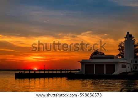 The midsummer sun sets behind the abandoned coast guard station in Cleveland Ohio