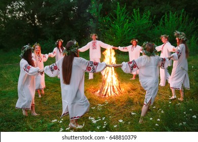 Midsummer. Young People In Slavic Clothes Circle Dance Around A 