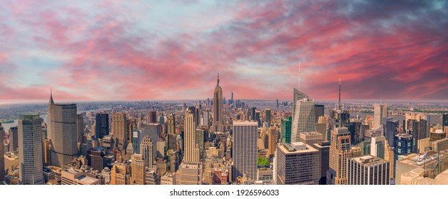 Midtown Manhattan at sunset, New York City. Panoramic aerial view of city skyscrapers at dusk.