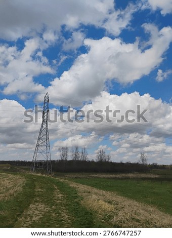 Midwest electrical tower grass clouds