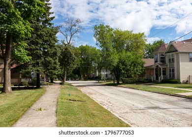 Midwest Neighborhood Street And Sidewalk With Old Homes And Green Trees During The Summer In Lemont Illinois