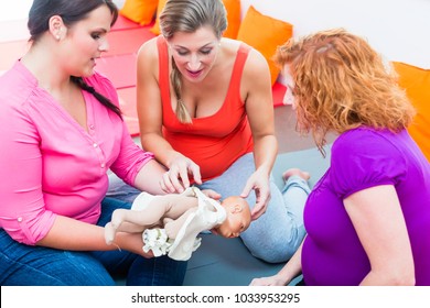 Midwife Explaining Birth Process To Pregnant Women During Antenatal Class With Anatomic Model Of Pelvic Bone