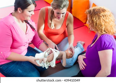 Midwife Explaining Birth Process To Pregnant Women During Antenatal Class With Anatomic Model Of Pelvic Bone