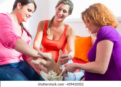 Midwife Explaining Birth Process To Pregnant Women During Antenatal Class With Anatomic Model Of Pelvic Bone