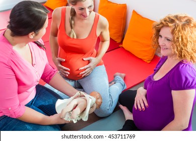 Midwife Explaining Birth Process To Pregnant Women During Antenatal Class With Anatomic Model Of Pelvic Bone