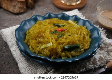 Mie Glosor, Bogor Traditional Cuisine.  Mie Aci Kuning From Tapioca, Which Is Stir-fried With Green Onions And Other Spices.  Served With Peanut Sauce And Fried Chili Sauce.  Many Are Available During