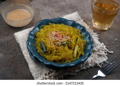 Mie Glosor, Bogor Traditional Cuisine.  Mie Aci Kuning From Tapioca, Which Is Stir-fried With Green Onions And Other Spices.  Served With Peanut Sauce And Fried Chili Sauce.  Many Are Available During