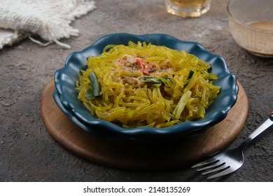 Mie Glosor, Bogor Traditional Cuisine.  Mie Aci Kuning From Tapioca, Which Is Stir-fried With Green Onions And Other Spices.  Served With Peanut Sauce And Fried Chili Sauce.  Many Are Available During