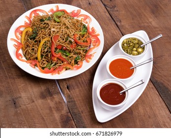 Mie Goreng Veg Noodles Served In A White Plate With Sauce On Wooden Background