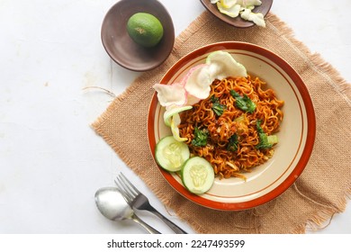 mie tek tek or fried noodle made with egg noodles with chicken, cabbage, mustard greens, meatballs, scrambled eggs. indonesian food