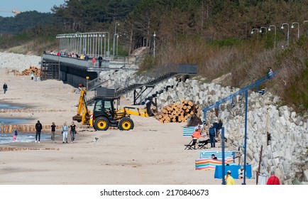 Mielno, Poland - May 23, 2022: Construction Of Breakwaters By The Beach In Mielno. Wide Beach With Construction Machinery. Repair Of Breakwaters.