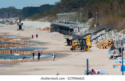 Mielno, Poland - May 23, 2022: Construction Of Breakwaters By The Beach In Mielno. Wide Beach With Construction Machinery. Repair Of Breakwaters.