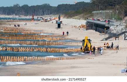 Mielno, Poland - May 23, 2022: Construction Of Breakwaters By The Beach In Mielno. Wide Beach With Construction Machinery. Repair Of Breakwaters.