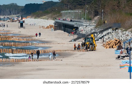 Mielno, Poland - May 23, 2022: Construction Of Breakwaters By The Beach In Mielno. Wide Beach With Construction Machinery. Repair Of Breakwaters.