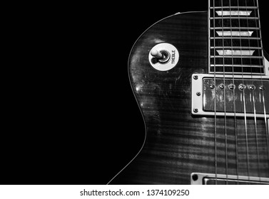 Miercurea Ciuc, Romania- 18 April 2019: Monochrome image , sunburst electric guitar on black background, space for text.