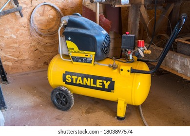 Miercurea Ciuc, Romania- 27 August 2020: Used dirty Stanley air compressor in a small woodworking shop.