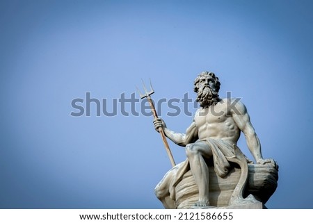 The mighty god of sea, oceans and water Neptune (Poseidon, Triton). Ancient statue against blue sky background. Copy space.