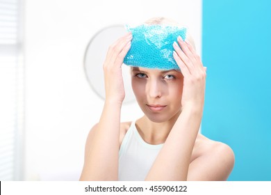 Migraine Headache.
The Woman Puts A Cold Compress To The Head 