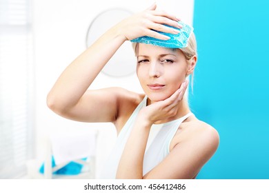 Migraine Headache.The Woman Puts A Cold Compress To The Head 