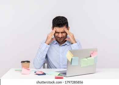 Migraine of stressful job. Depressed man employee sitting in office, clasping head temples, suffering headache and tension, worried about problems at work. studio shot isolated on white background