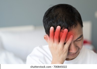 Migraine symptoms in businessman. Man suffering from pulsating pain of one sided headache. People medical healthcare concept