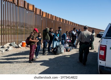 Migrants from Columbia wait to be processed after turning themselves over to authorities at the United States and Mexico border May 12, 2021 in Yuma, Arizona.