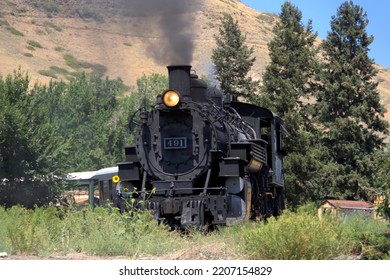 Mikado Type Steam Engine 491 Pulling A Passenger Train Through Scenic Countryside