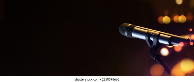 mike live and voice concept.Close-up the microphone on stand for speaker speech presentation stage performance with blur and bokeh on black background.