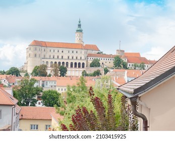 Mikulov city and castle. Street and houses of historic Czech town Mikulov with castle and blue sky