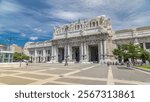 Milan antique central railway station timelapse hyperlapse. Blue cloudy sky at summer day. The station was inaugurated in 1931.