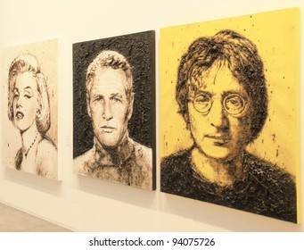 MILAN - APRIL 08: Looking at paintings dedicated to Marilyn Monroe, Paul Newman and John Lennon at MiArt, international exhibition of modern and contemporary art on April 08, 2011 in Milan, Italy.