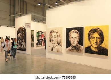 MILAN - APRIL 08: People look at paintings dedicated to Marilyn Monroe, Paul Newman and John Lennon at MiArt, international exhibition of modern and contemporary art on  April 08, 2011 in Milan, Italytthanks