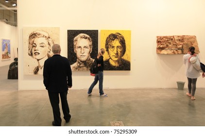 MILAN - APRIL 08: People look at paintings dedicated to Marilyn Monroe, Paul Newman and John Lennon at MiArt, international exhibition of modern and contemporary art on April 08, 2011 in Milan, Italy.