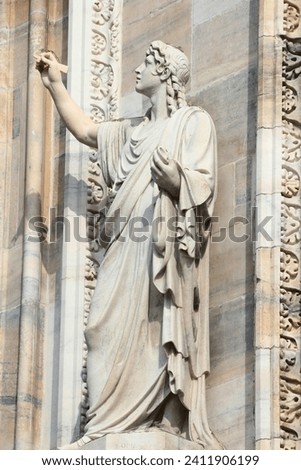 Milan Cathedral, Italy. Gothic style marble saint statue. Italy landmark. Stonework art detail.