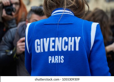 MILAN - FEBRUARY 21: Woman with blue and white Givenchy jacket before Alberta Ferretti fashion show, Milan Fashion Week street style on February 21, 2018 in Milan.