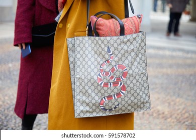 MILAN - FEBRUARY 24: Woman With Gucci Bag With Red Snake And Yellow Coat Before Tod's Fashion Show, Milan Fashion Week Street Style On February 24, 2017 In Milan.