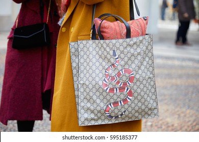 MILAN - FEBRUARY 24: Woman With Gucci Bag With Red Snake And Yellow Coat Before Tod's Fashion Show, Milan Fashion Week Street Style On February 24, 2017 In Milan.