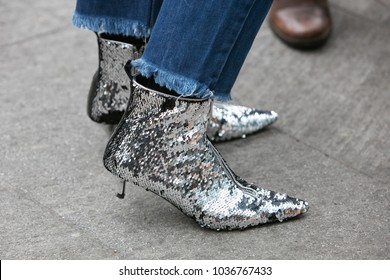 MILAN - FEBRUARY 25: Woman With Silver Sequin Shoes And Blue Jeans Before Emporio Armani Fashion Show, Milan Fashion Week Street Style On February 25, 2018 In Milan.