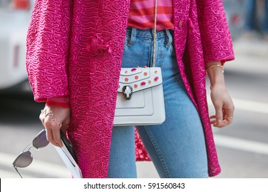 MILAN - FEBRUARY 25: Woman With White Bulgari Bag And Pink Jacket Before Ermanno Scervino Fashion Show, Milan Fashion Week Street Style On February 25, 2017 In Milan.