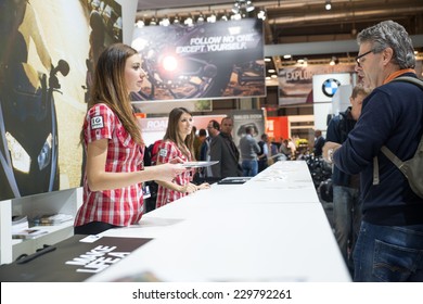 MILAN, IT. NOVEMBER 5, 2014. Hostess Giving Fliars At Bmw Motorrad Stand At EICMA 2014.BMW Motorrad Is The Motorcycle Brand Of The German Company BMW.