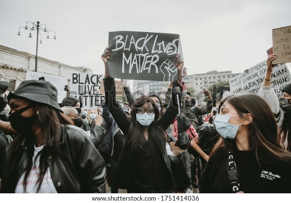 Milan, Italy - 07 June\
2020: Black lives matter movement protesting in Milan, claiming for\
antiracism and equal human rights holding \