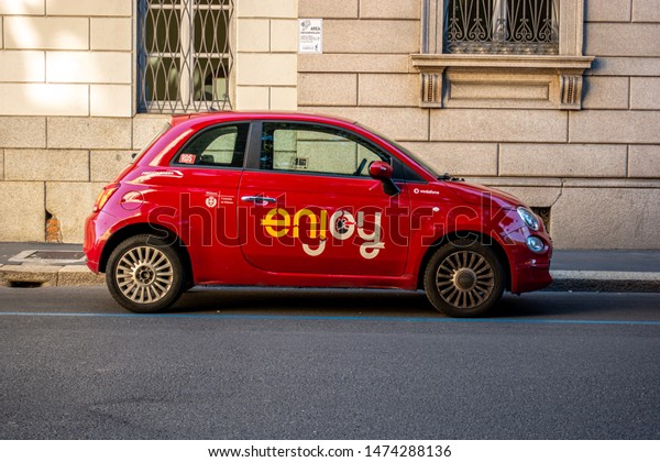 Milan, Italy 08.08.2019 Sharing economy of Milan\
operated by the municipality of the city. Small red Fiat 500\
vehicles called \