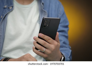 Milan, Italy - 21 April 2021: a Man Holding The Samsung Galaxy A72 Black, Samsung Midrange Smart Phone