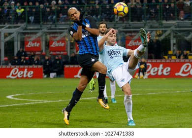 Milan, Italy. 30 December 2017. Campionato Italiano Di SerieA, Inter Vs Lazio 0-0. Stefan Radu, Lazio And Joao Mario, Inter, Vie For The Ball.