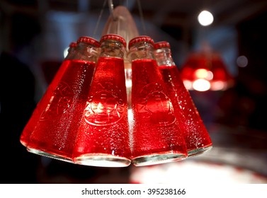 MILAN, ITALY - 4 SEPTEMBER 2013: Bottles Of Campari Soda Hang On Display Inside A Gallery.