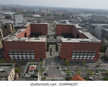 Milan, Italy - April 2022 - Aerial view of Bicocca University campus in Milan, near station of Greco Pirelli. Drone and birds eye of one of the best university in Milano. Modern red buildings.