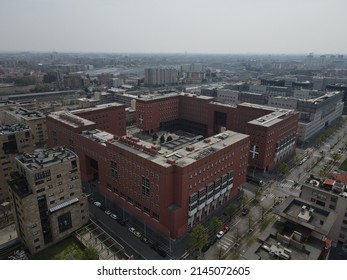 Milan, Italy - April 2022: Aerial view of Bicocca University campus in Milan, near station of Greco Pirelli. Drone and birds eye of one of the best university in Milano. Modern red buildings.