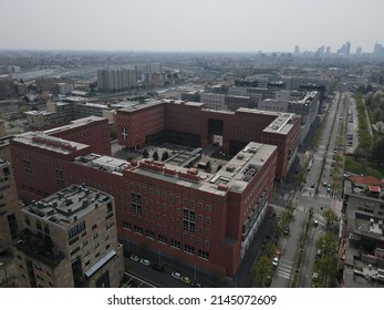 Milan, Italy - April 2022: Aerial view of Bicocca University campus in Milan, near station of Greco Pirelli. Drone and birds eye of one of the best university in Milano. Modern red buildings.