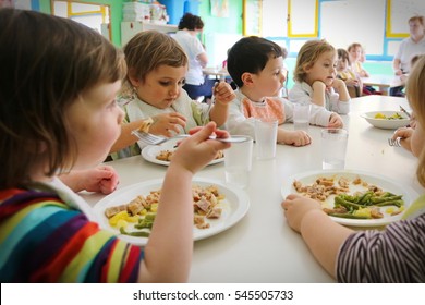 Milan, Italy - April 4, 2014: Pupils Enjoying Healthy Lunch In Cafeteria